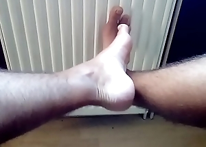 Boy shows his tanned feet